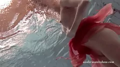 Play Watch Katya Okuneva's seductive underwater striptease in her red lingerie, showcasing her juicy pussy and big hot tits